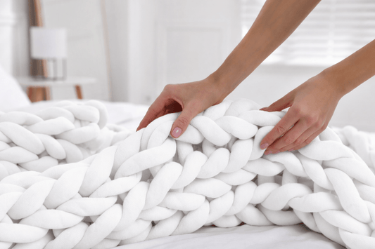 BloomKnit™ Chunky Cotton Weighted Blanket in Pure Calm on a bed, showcasing its soft and luxurious texture.