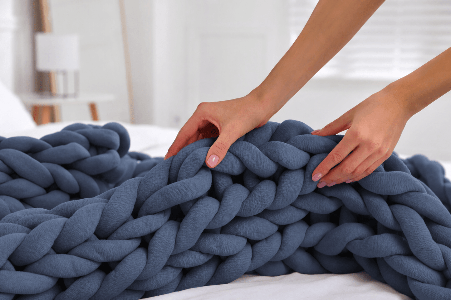  BloomKnit™ Chunky Cotton Weighted Blanket in Slate on a bed, showcasing its soft and luxurious texture.